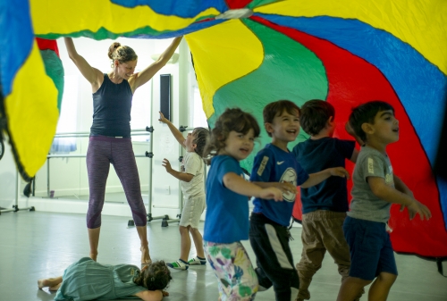 Sarah Gladwin Camp and kids playing with a parachute