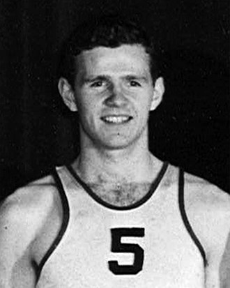 James “Jim” Reilly ’50 wears a basketball jersey and smiles. He was one of the most prolific scorers in Swarthmore College men’s basketball history and an NBA draft pick of the Minneapolis Lakers. 