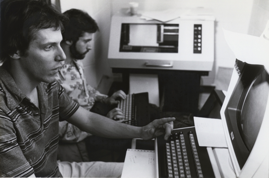 John Bowe ’83 and Larry Ehmer ’82 looking at computer screens