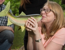 woman kissing a fish