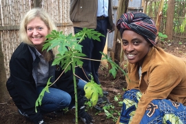 Erica Barks-Ruggles plants a tree with a native woman of Rwanda.