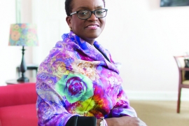 President Valerie Smith sits wearing a multicolored scarf