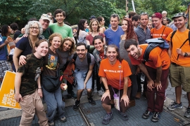 A group of smiling people take part in the People's Climate March in New York City.