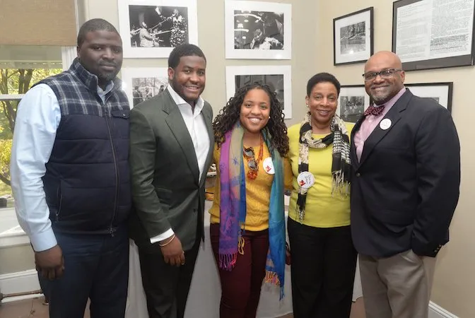 Five members of a Swarthmore alumni affinity group standing and smiling