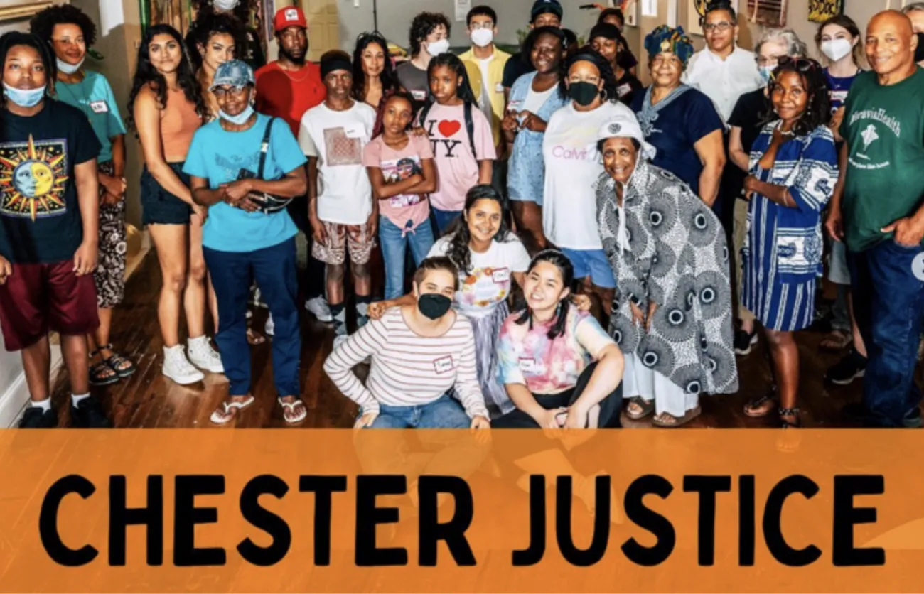 People gathered over a sign that says Chester Justice in all caps