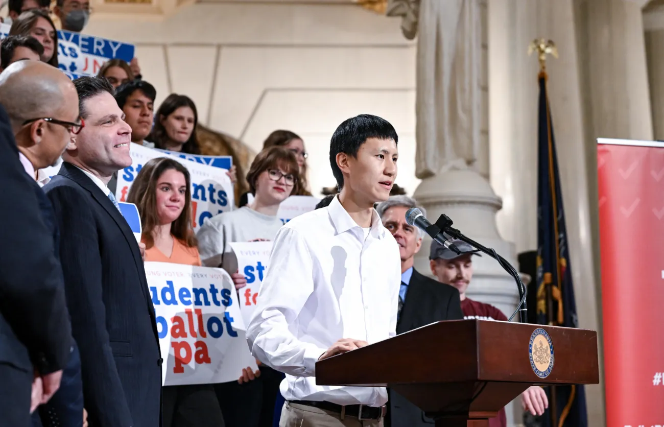 Harry Hou giving a speech before members of the House, spotlighting the convergence of students coming together to rally for election reform.