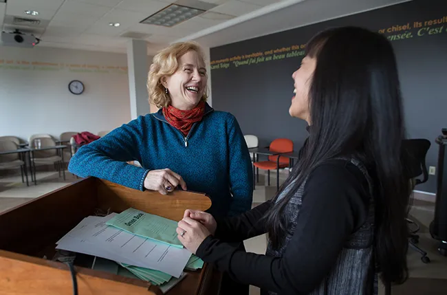 Professors Betsy Bolton and Tomoko Sakumura enjoy a classroom collaboration