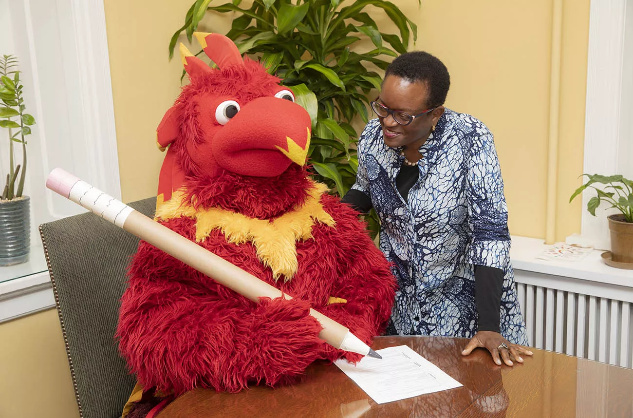 the mascot getting advice from president smith