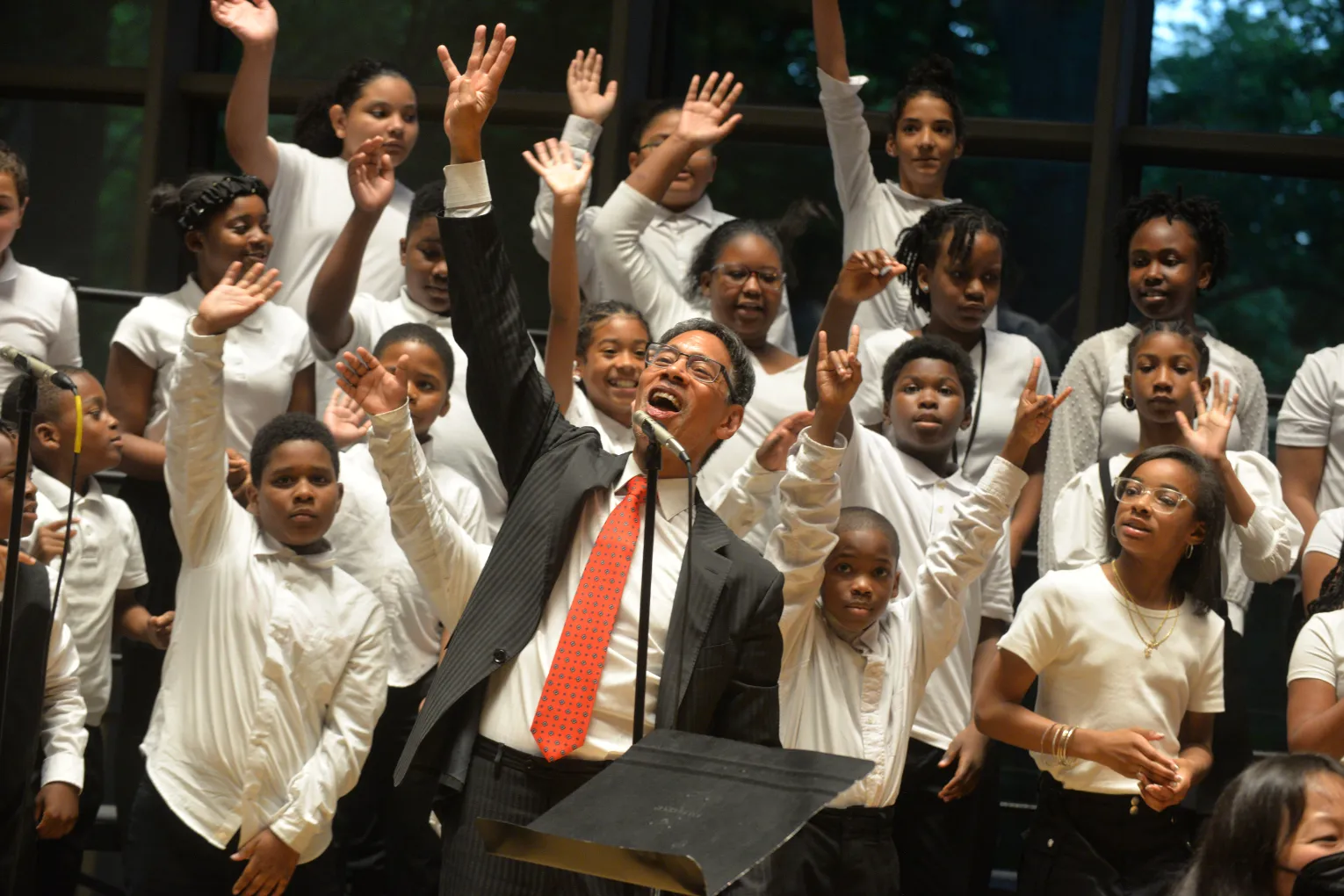 John Alston with children waving behind him