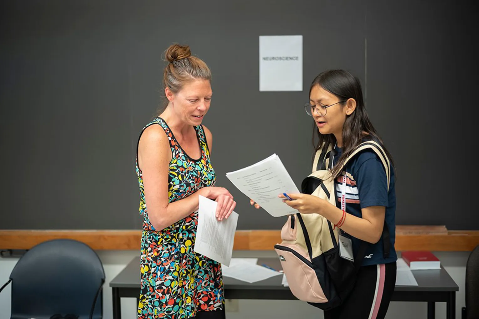 student speaks with professor