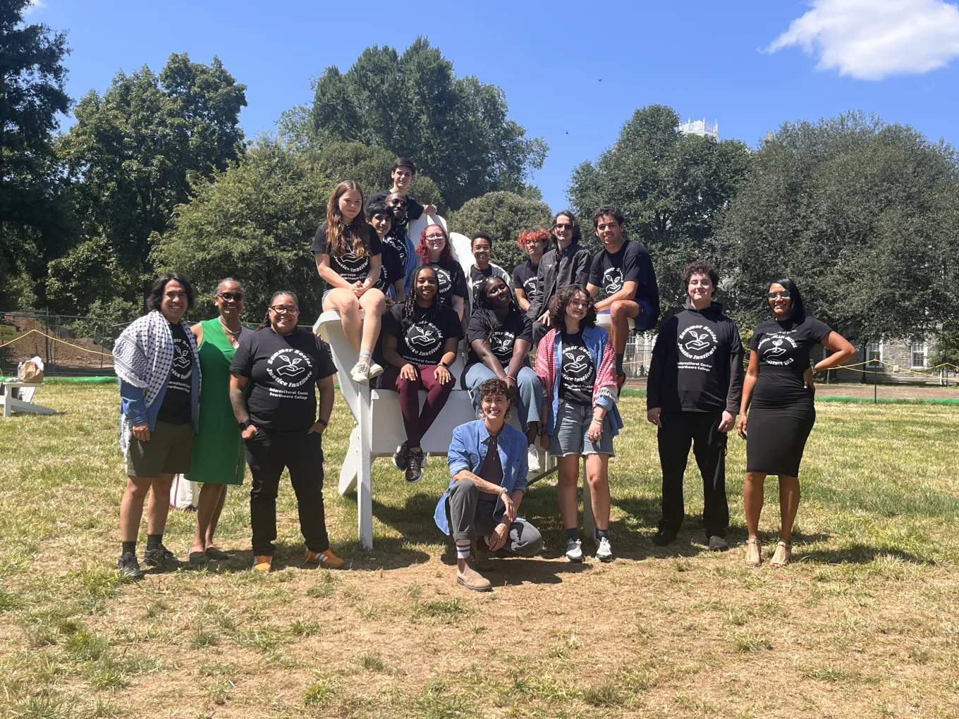 SSJI cohort of students and staff around the Big Chair on Parrish Beach