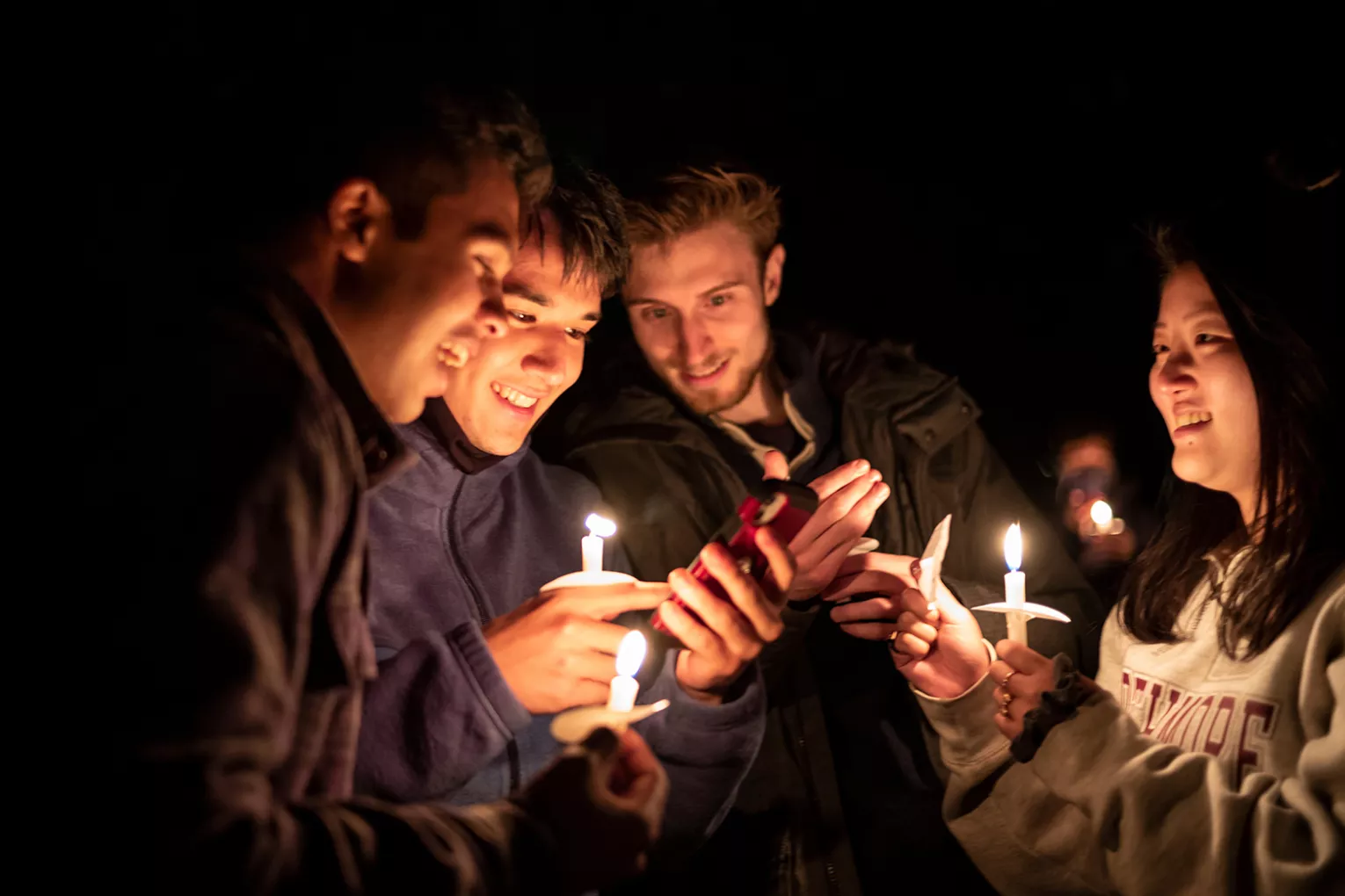 Students share candles outdoor