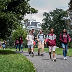 Students walk down path with Parrish in background