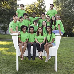 Summer scholars pose for group photo in big chair