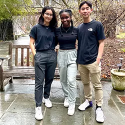 Three members of mock trial team pose outdoors