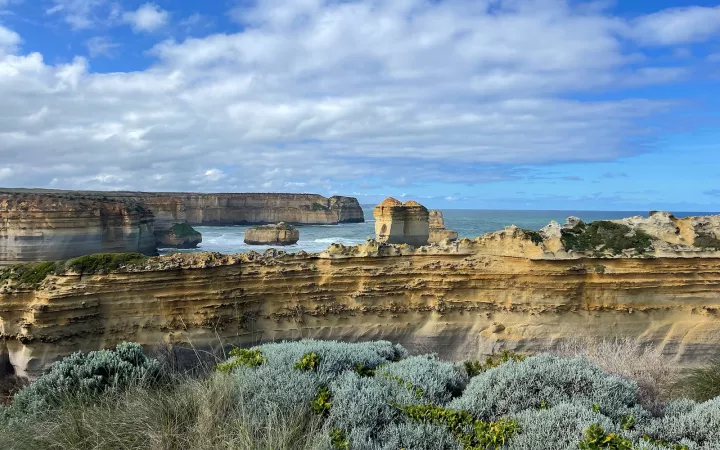 Rocky cliffs with striped pattern leading to ocean