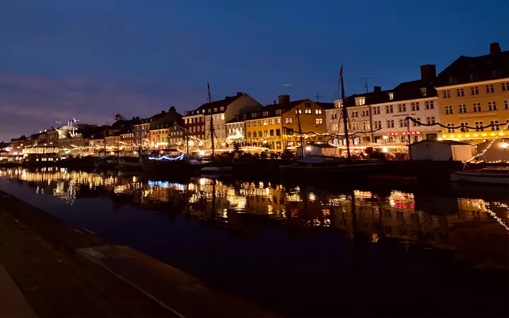 Town with bright lights along riverside at night