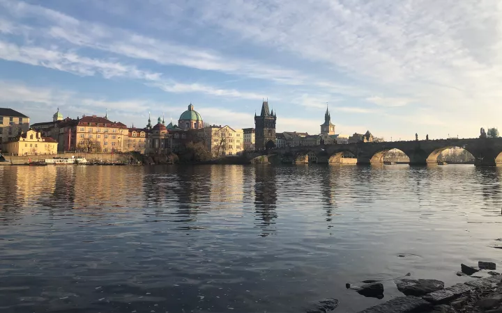 Expanse of water with bridge and buildings in distance