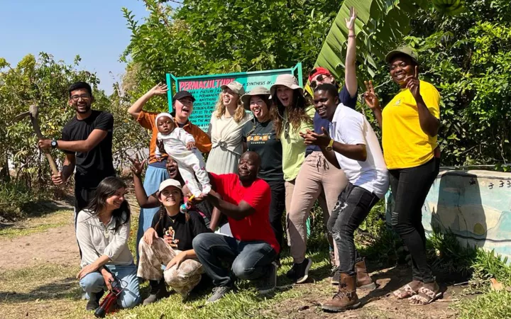 Group making silly expressions in front of path into forest