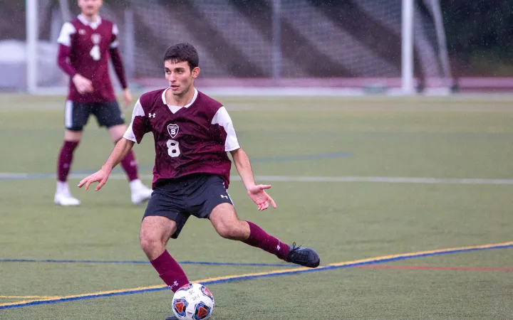 Soccer player kicks ball