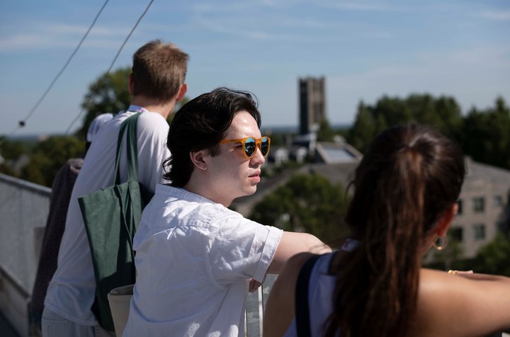 Alumni examine campus of Swarthmore college from roof