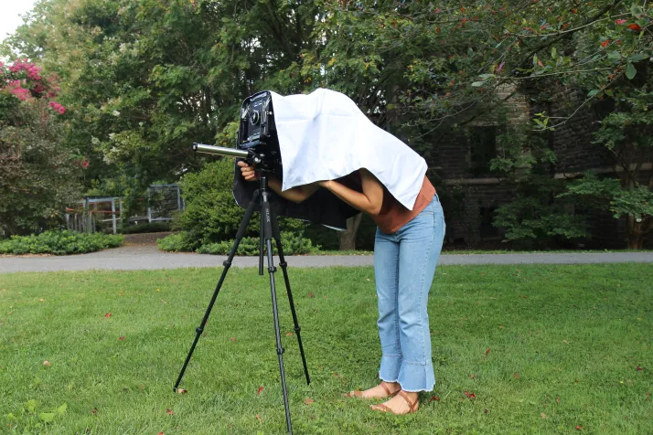 Photography I student in the field with a large format camera