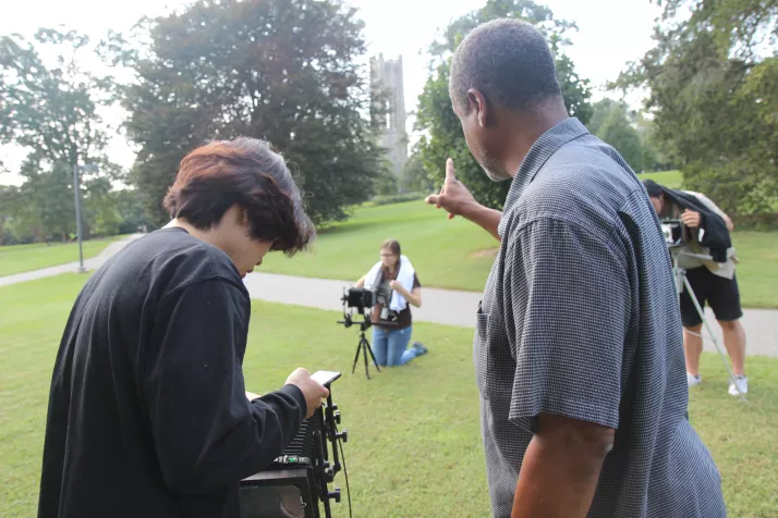 Student consulting with Ron Tarver on their large format camera photography shot.