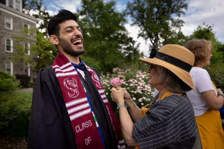 Person receives rose in garden