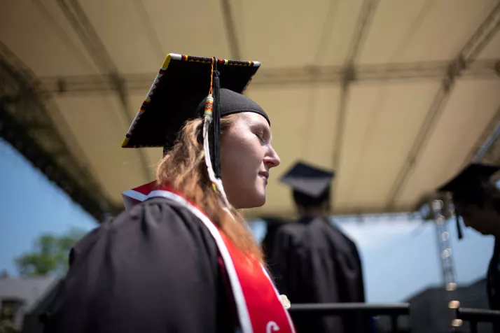 Student walks at commencement