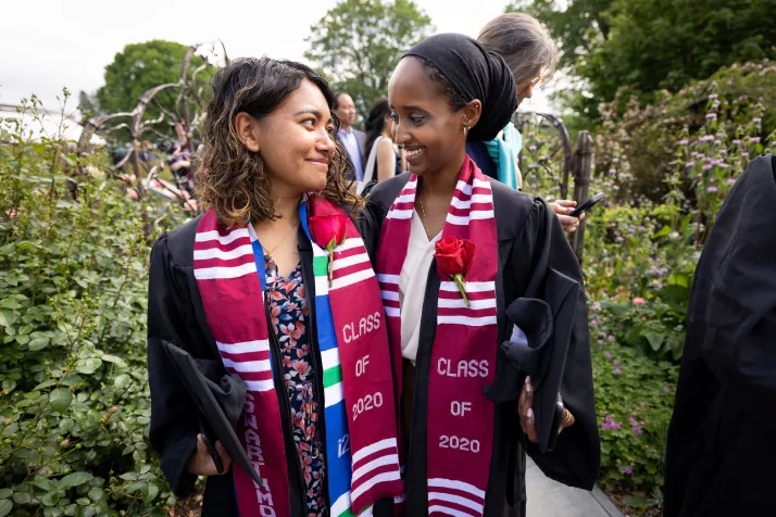 Two graduates pose together