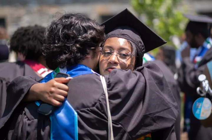 Graduates hug