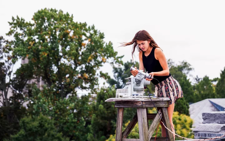 student working on experiment on roof top 