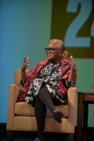 President Smith sitting on chair during discussion