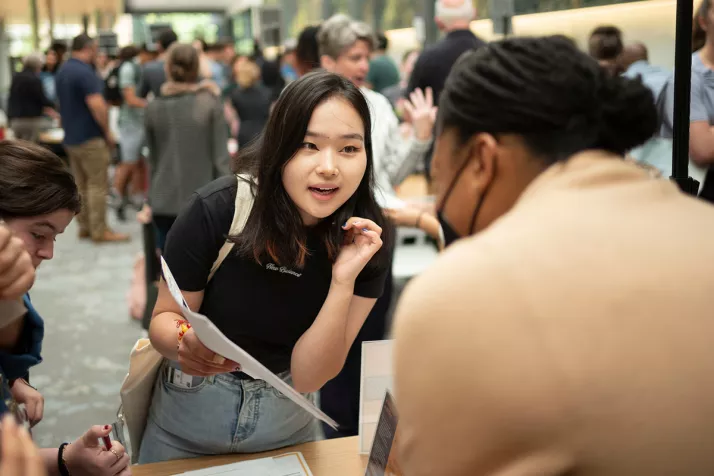 Student talks to professor at academic advising fair