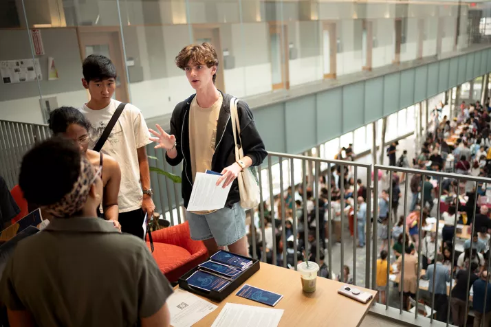 Student talks to professor at academic advising fair