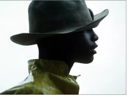 A 14-year-old boy wears a worn felt hat during a trail ride south of Austin, Texas.