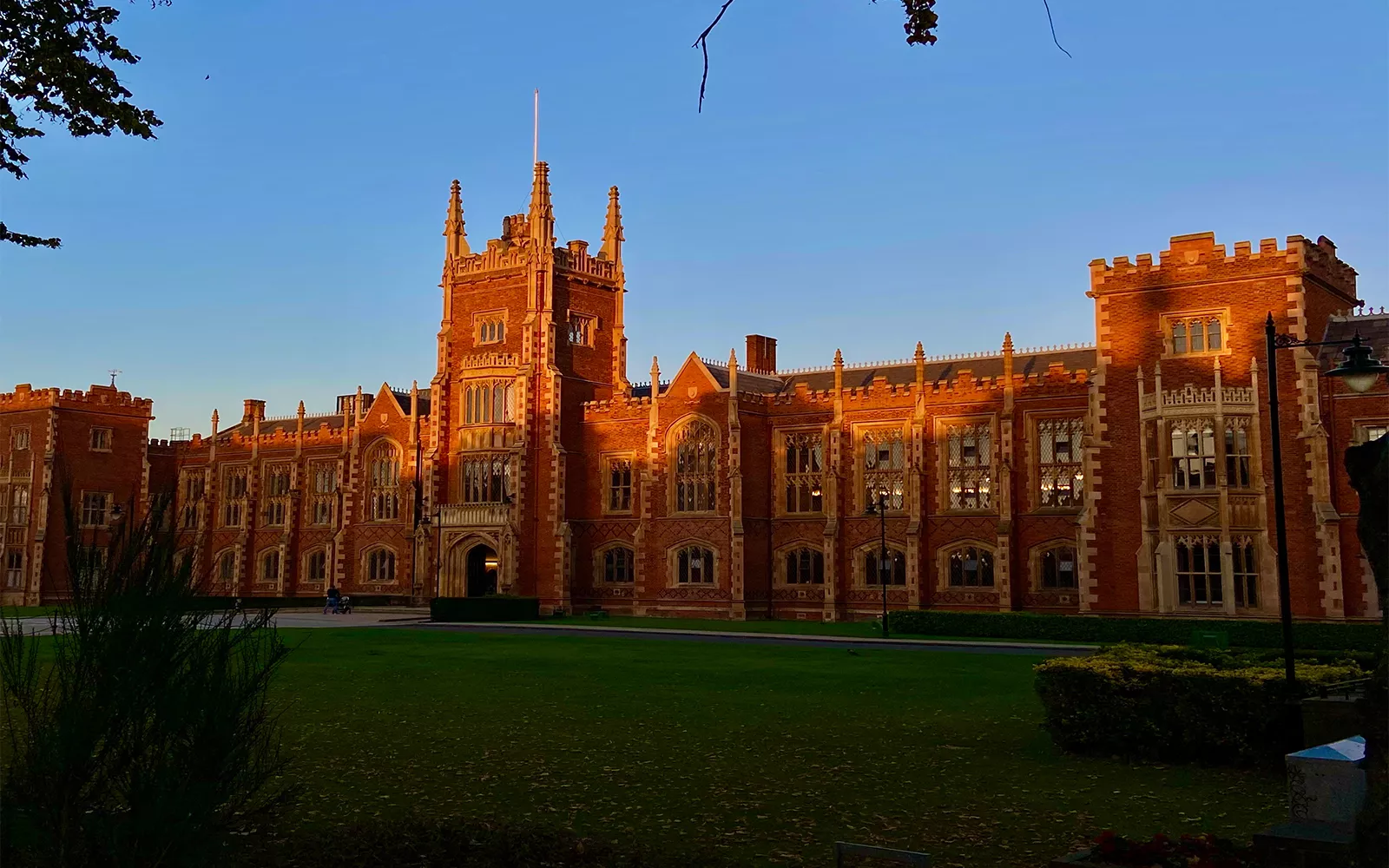 Stately brick building cast in orange light