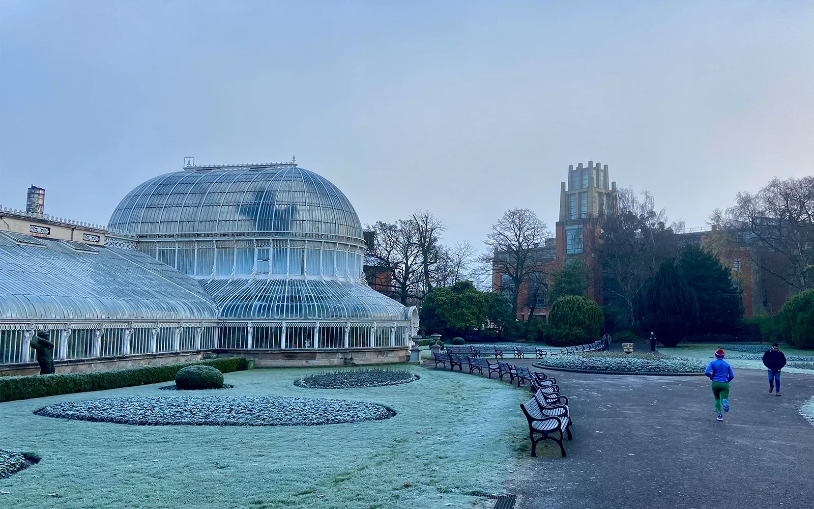 Domed glass building next to frosty ground and path