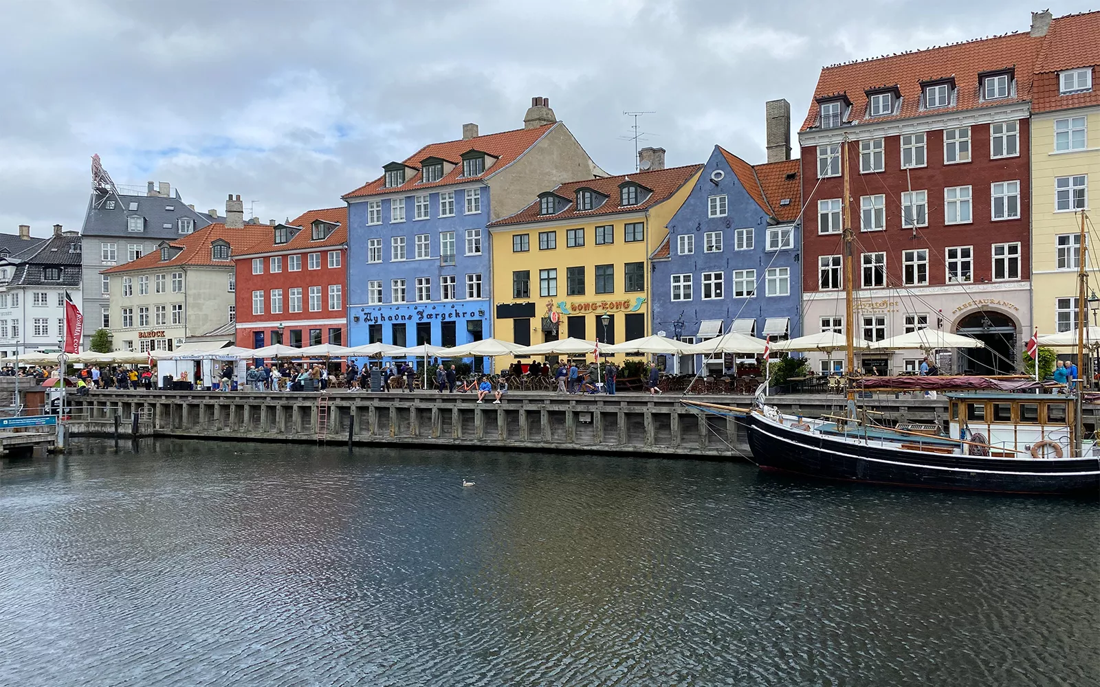 Colorful downtown scene behind body of water with boat