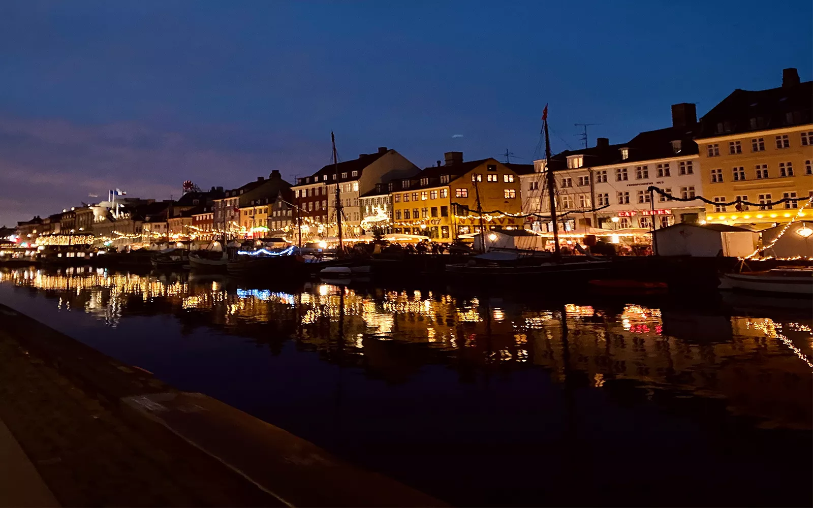 Town with bright lights along riverside at night