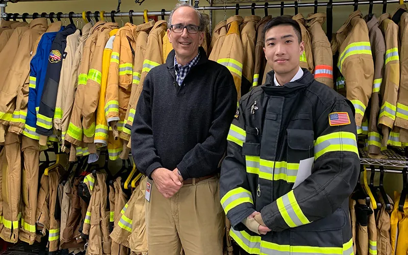 Student and mentor in fire coats