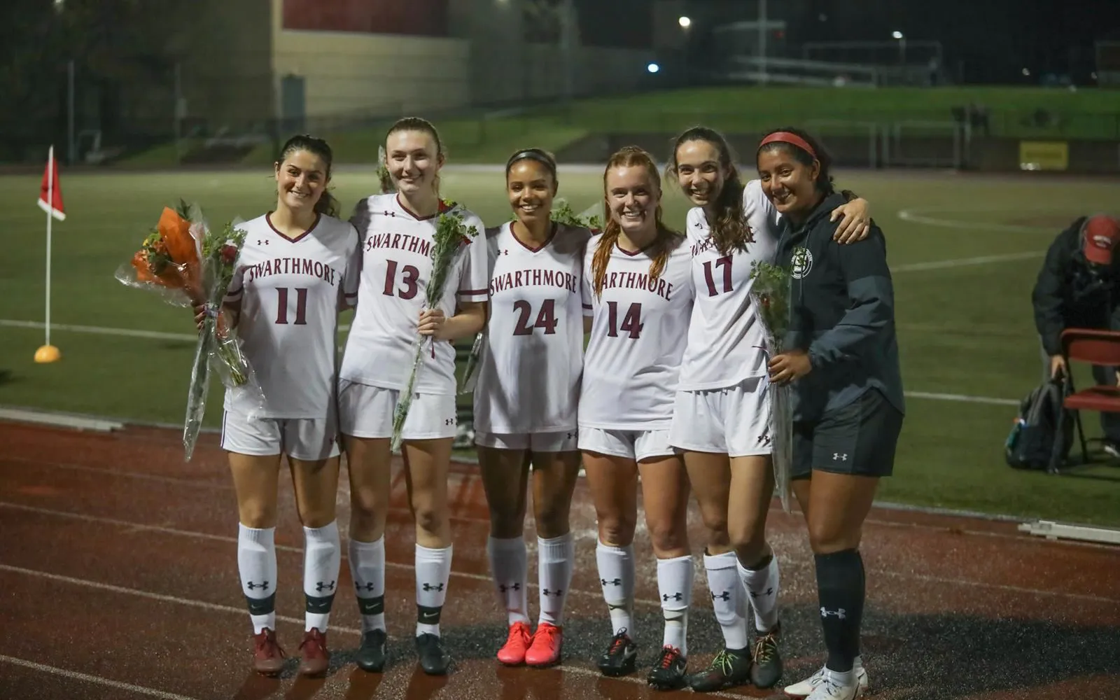 Soccer players pose in group with roses