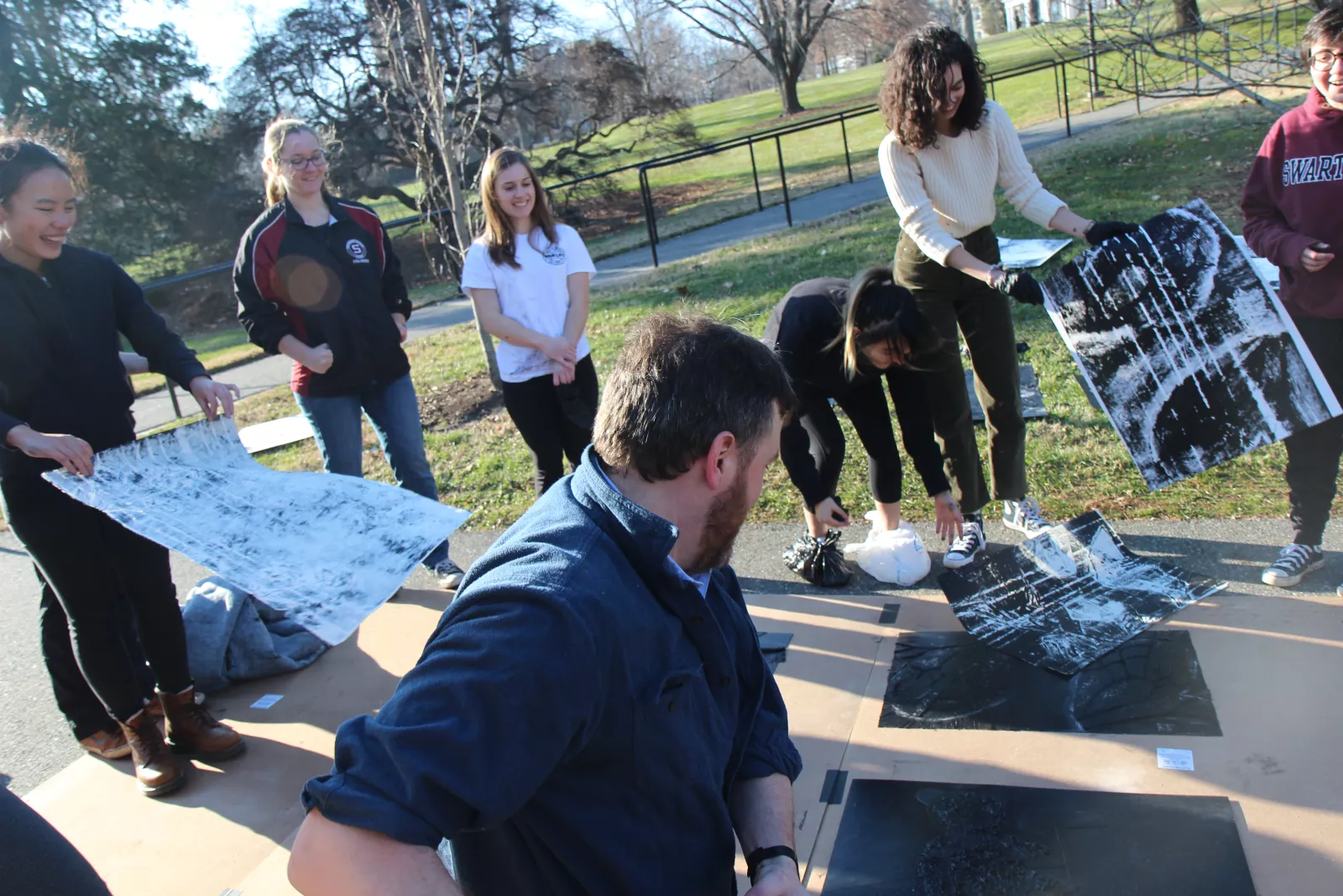 Painting students work on a project outdoors.