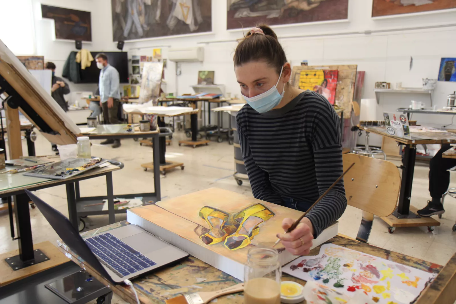 Student painting during Painting III: Studio Materials and Methods.