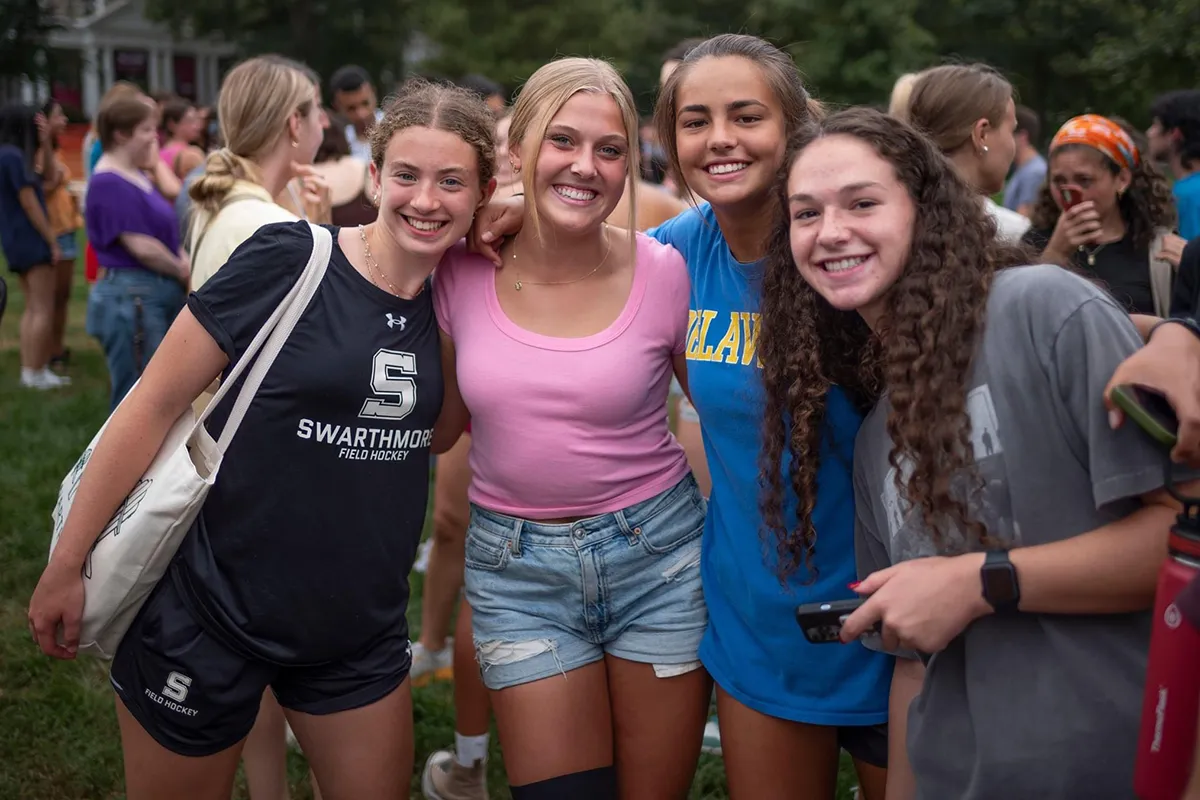 Group of students stand and smile for posed picture