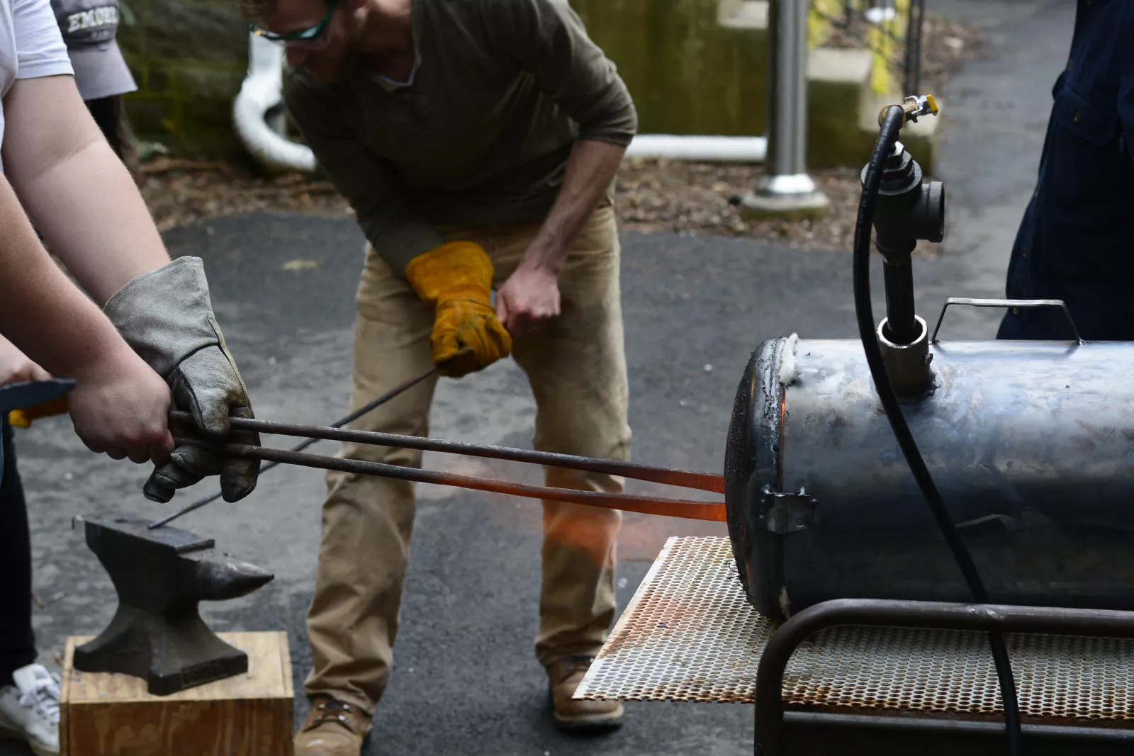 Students maneuver metals into an oven