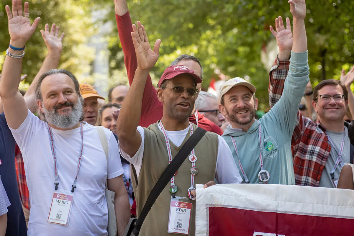 Group of people wave during Parade of Classes