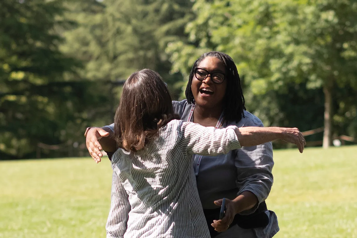 Two people hug at alumni weekend