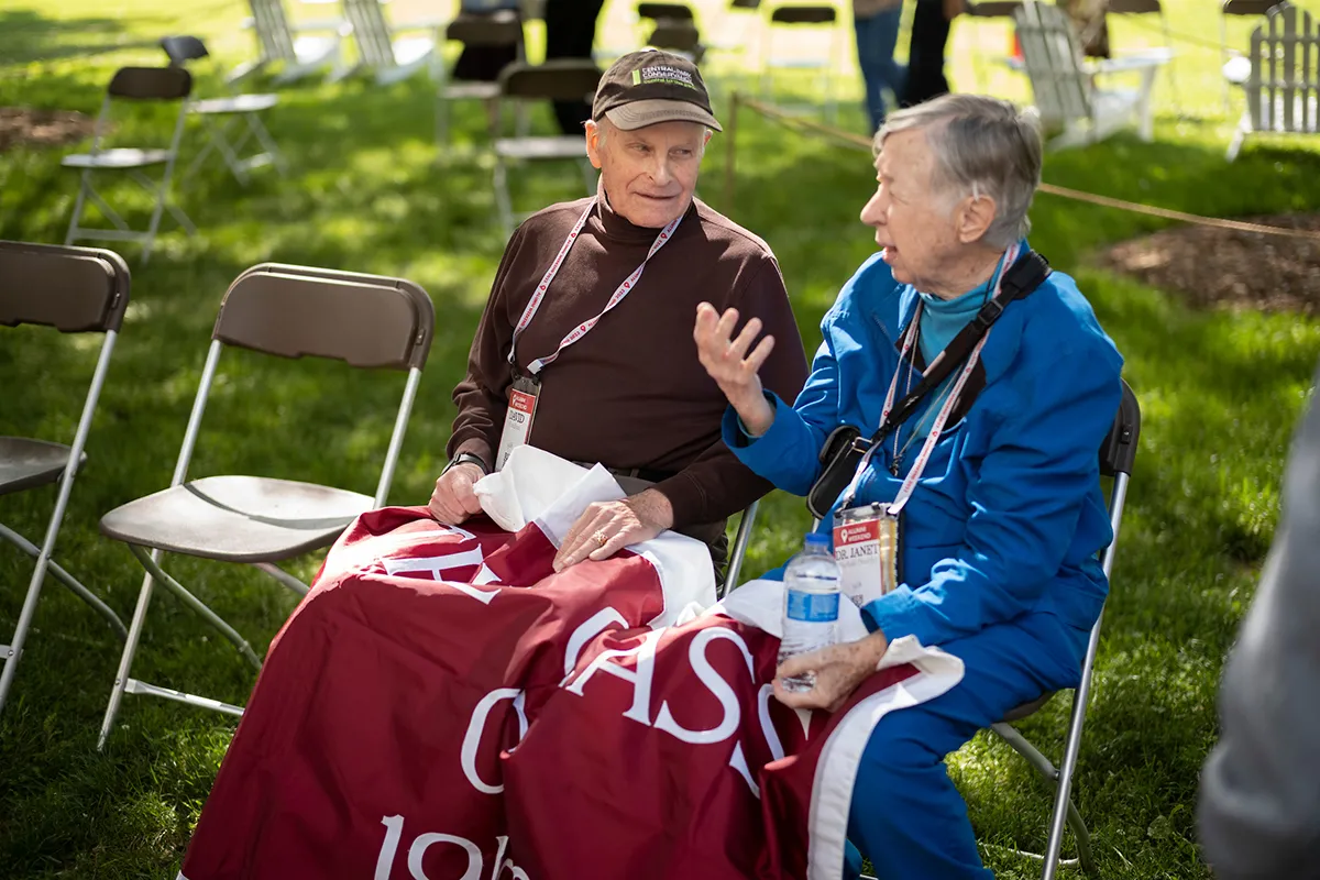 Two people sit in chairs next to each other