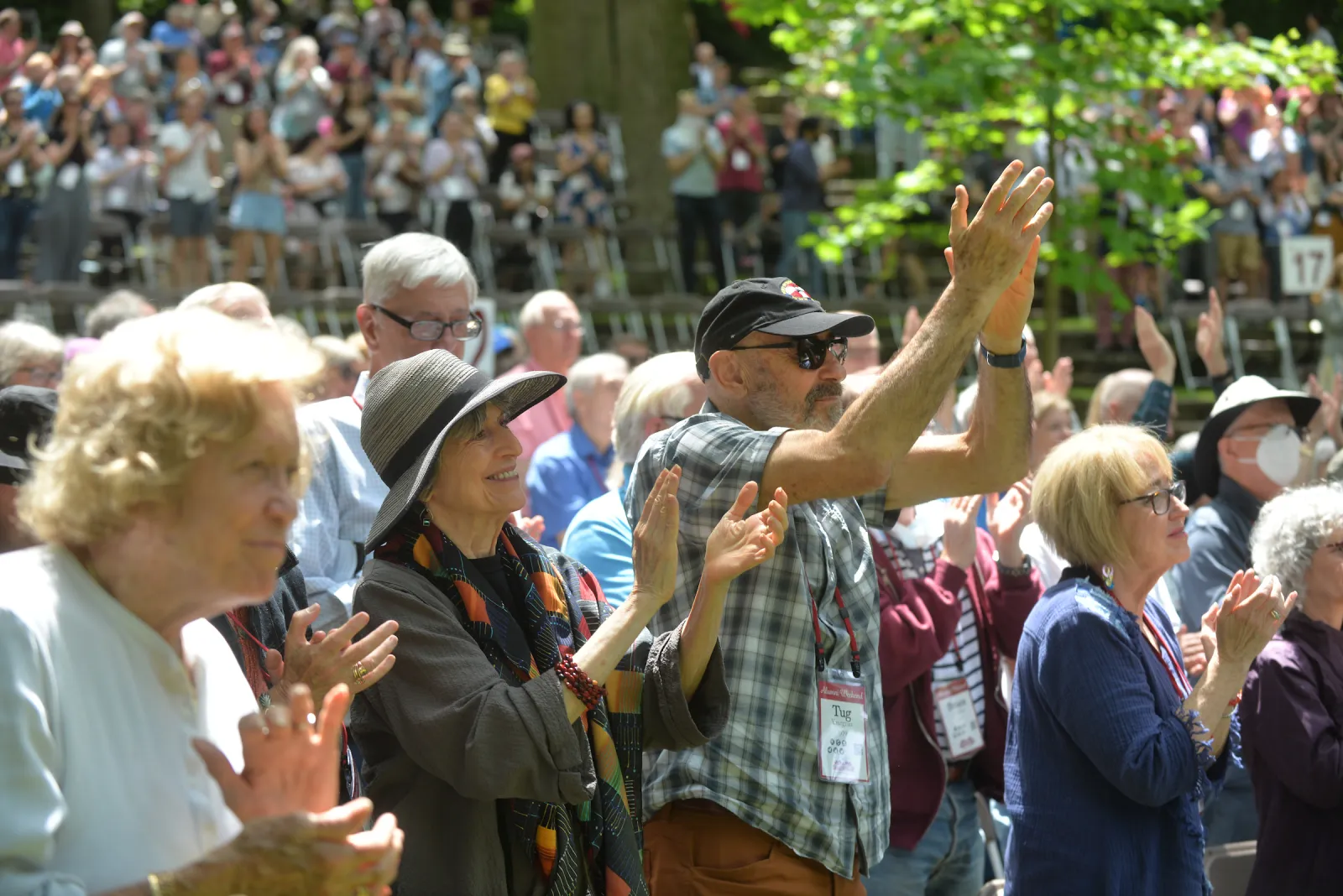 Crowd applauds in outdoor amphitheater